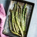Parmesan Roasted Asparagus on a metal sheet pan with a pink napkin.