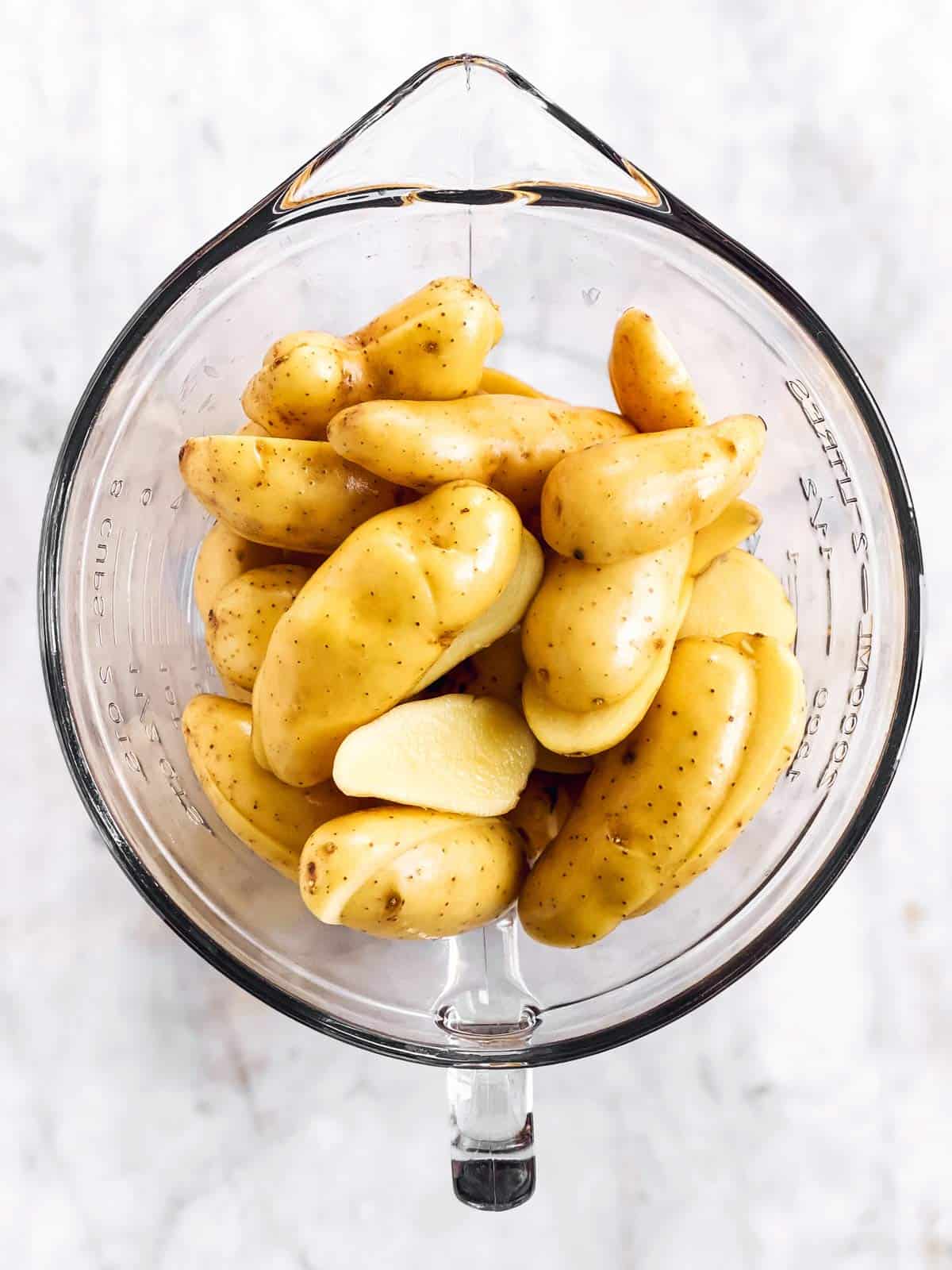 glass bowl filled with halved fingerling potatoes
