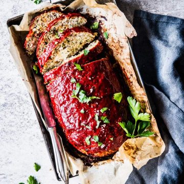 greek Turkey zucchini meatloaf sliced on a tray