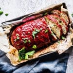 Turkey Zucchini Meatloaf on a sheet pan with a dark napkin.