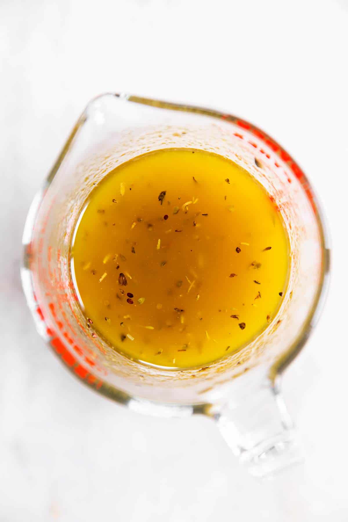 overhead view of balsamic vinaigrette in glass measuring jug