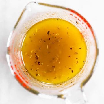 overhead view of balsamic vinaigrette in glass measuring jug