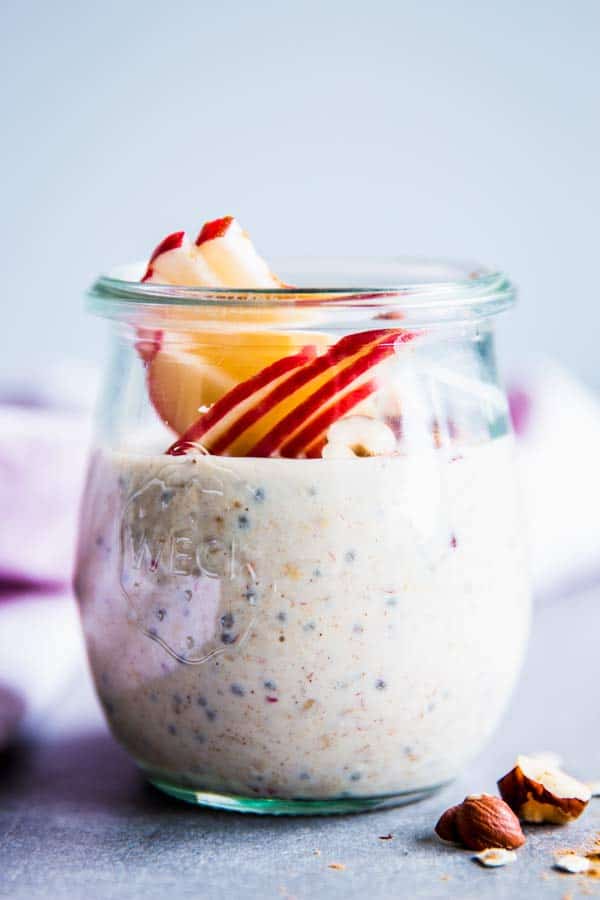 Apple Cinnamon Overnight Oats are a quick and easy make ahead breakfast the whole family will enjoy! It’s perfect for the first days of fall. Meal prep friendly, kid friendly and so healthy, too! | #recipe #easyrecipes #mealprep #apples #cinnamon #applerecipes #overnightoats #fall #fallfood #fallrecipes #healthy #healthyrecipes #healthyfood #cleaneating apple cinnamon overnight oats in a glass jar