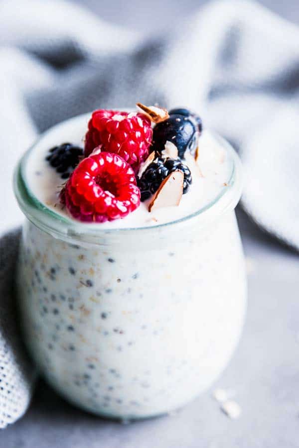 close up photo of basic overnight oats with berries on top