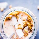 Carrot Cake Overnight Oats in a jar with walnuts and coconut.