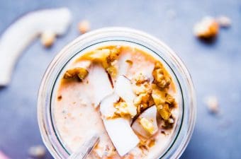 Carrot Cake Overnight Oats in a jar with walnuts and coconut.