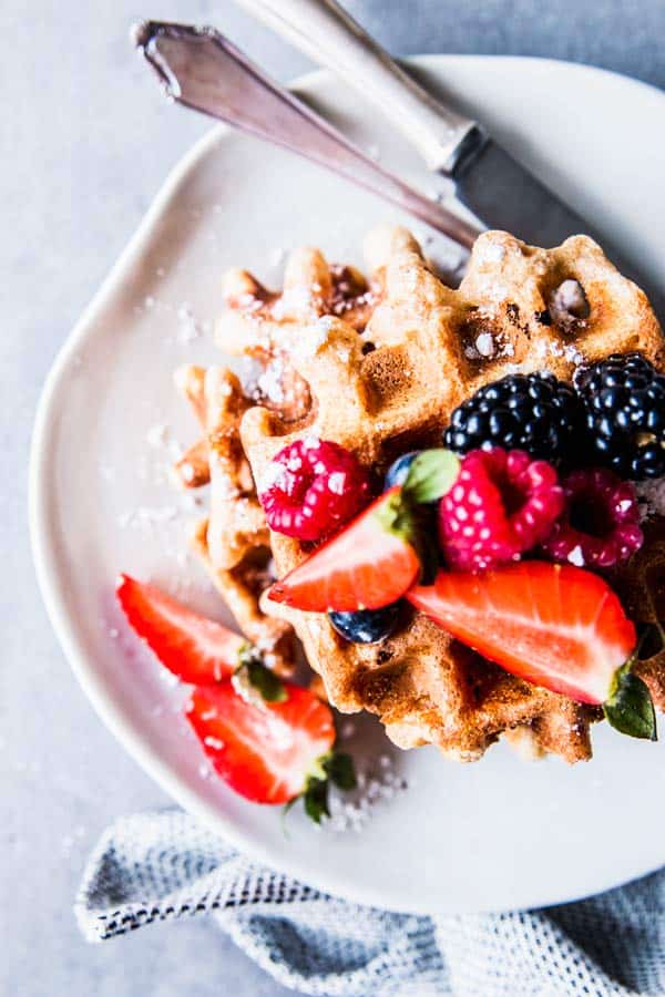 Fluffy Whole Wheat Waffles on a small plate with cutlery.