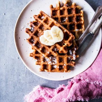 Healthy Banana Waffles on a white plate with a pink napkin.