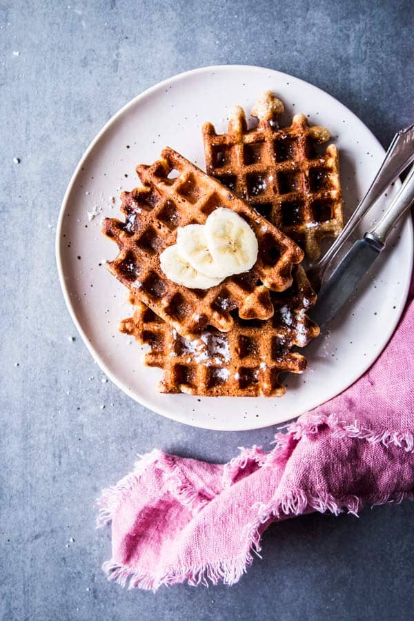 Healthy Banana Waffles on a white plate with a pink napkin.