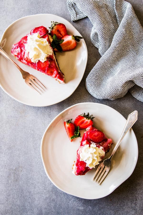 Two slices of no bake strawberry pie on plates.