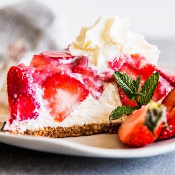 No Bake Strawberry Pie on a plate with fresh strawberries.