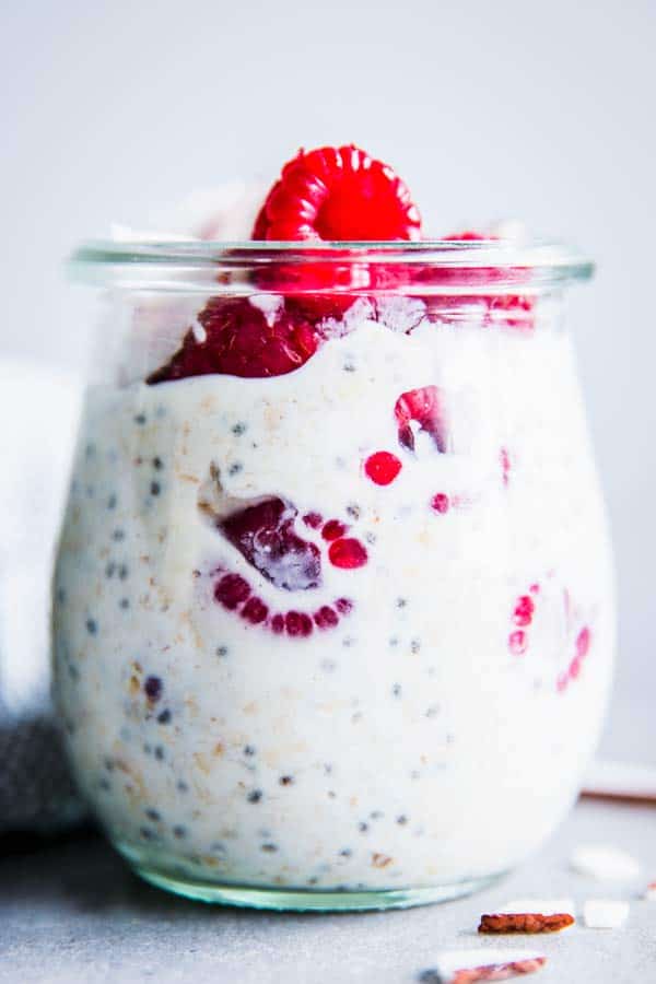 Raspberry Coconut Overnight Oats in a glass jar.