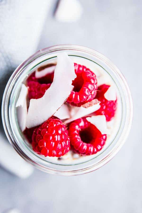 Raspberry Coconut Overnight Oats in a glass jar from above 