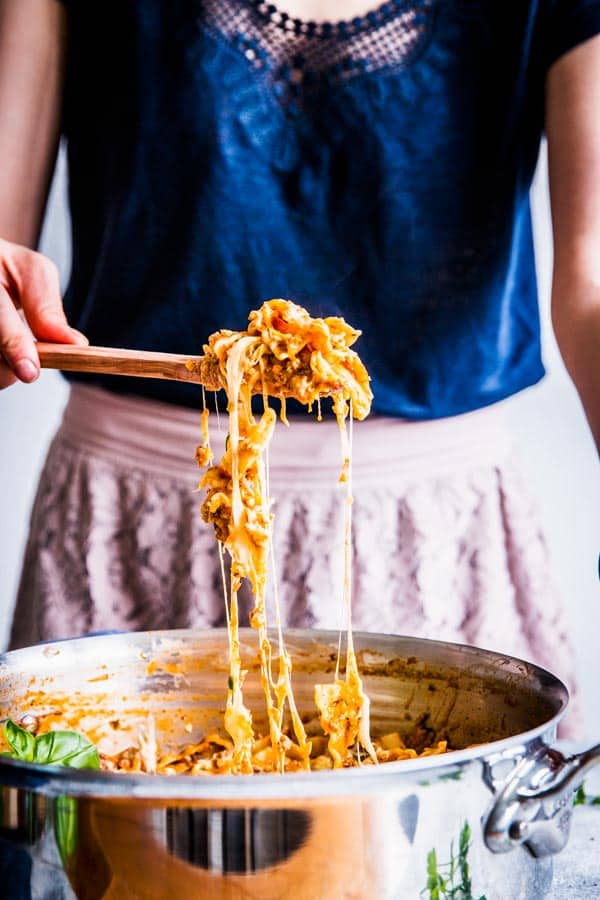 Woman serving skillet lasagna