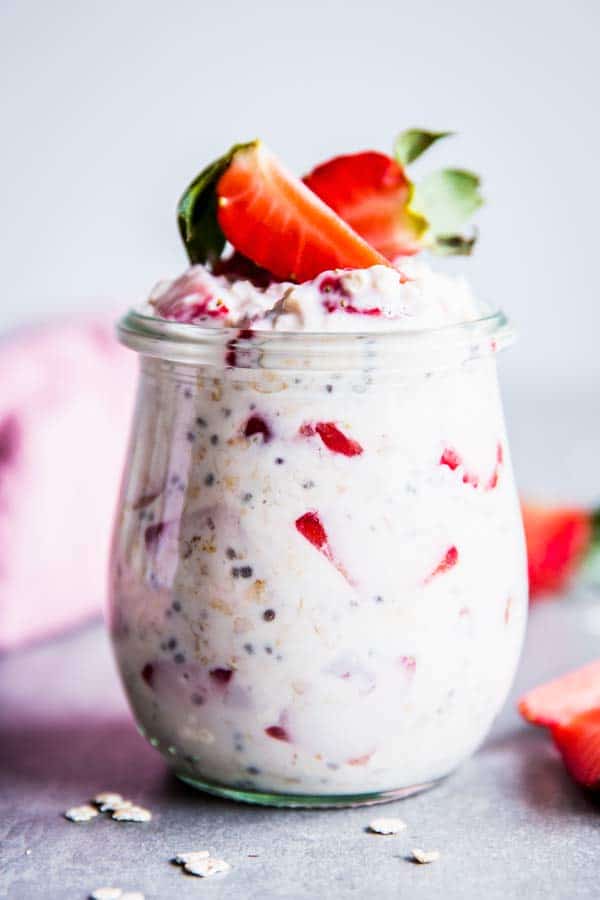 Vanilla Strawberry Overnight Oats on the table in a jar.