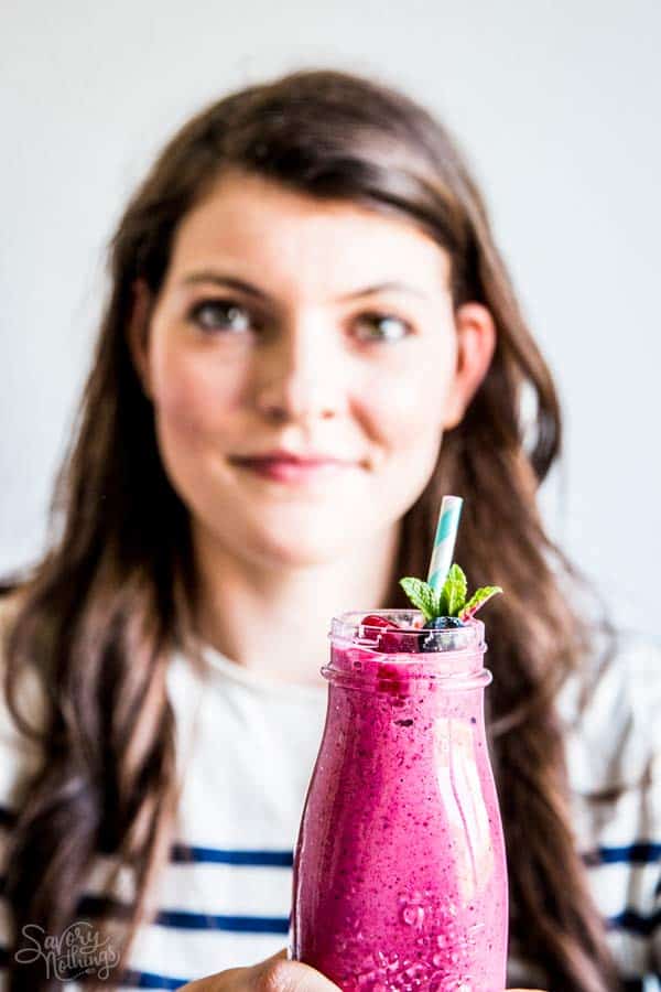 woman with a berry smoothie