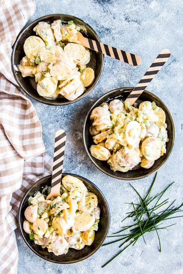 three plates with creamy greek yogurt potato salad