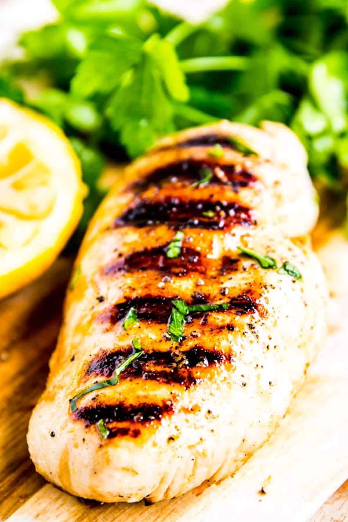 lemon garlic grilled chicken on a wooden board