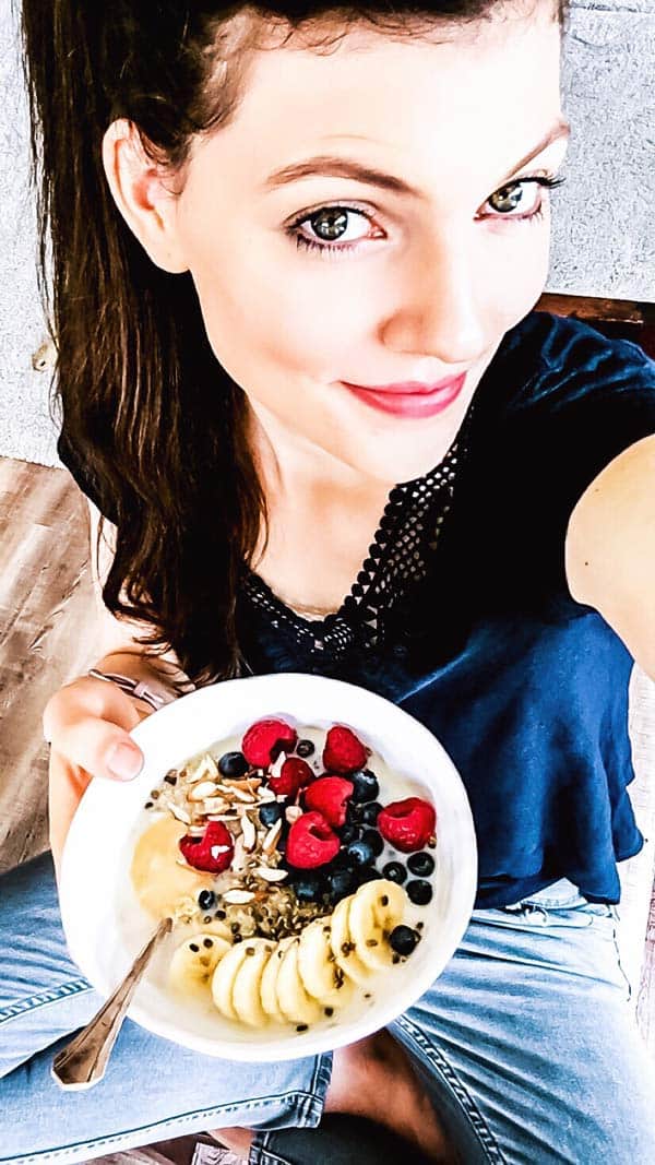 woman with a quinoa breakfast bowl