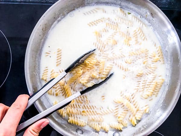 pasta in milk in a skillet