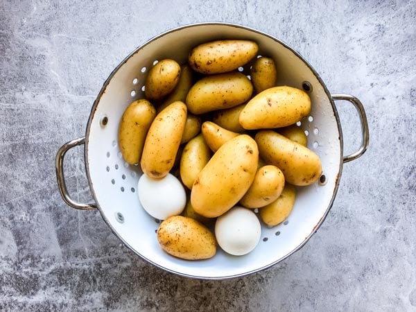 potatoes and eggs in a colander