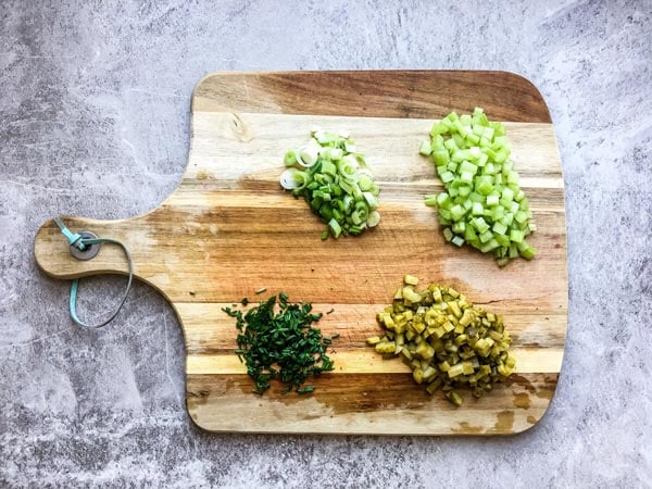 chopped herbs and vegetables for greek yogurt potato salad