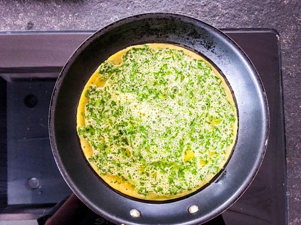 cooking a green goddess omelette in a non stick skillet