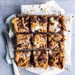 oatmeal cookie s'mores bars cut on a baking sheet with a knife