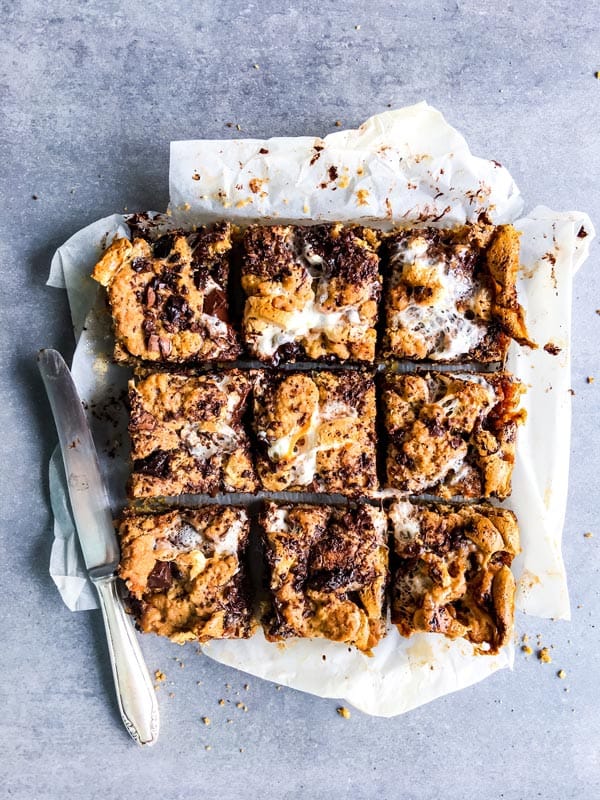 oatmeal cookie s'mores bars cut on a baking sheet with a knife