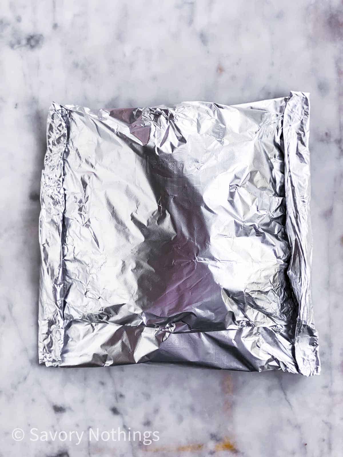 sealed foil pouch on light marble surface