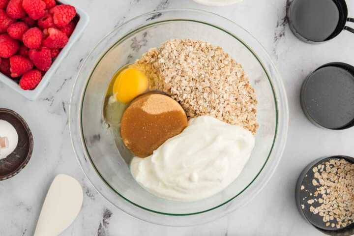 oats and wet muffin ingredients in glass bowl