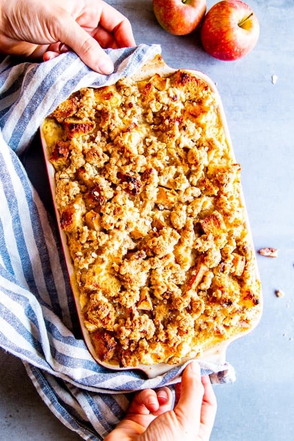 putting a casserole dish with apple French toast bake on the table