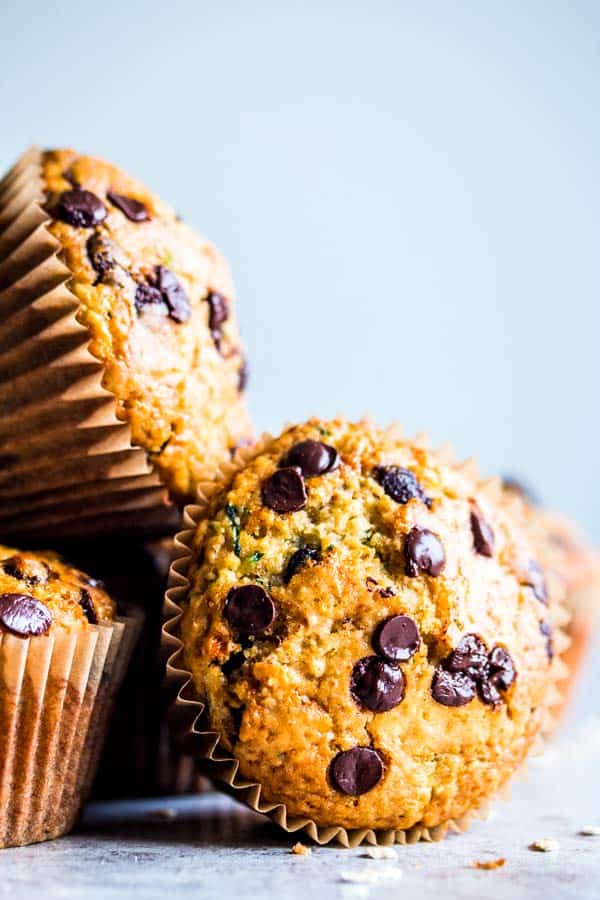 a stack of chocolate chip zucchini muffins on the counter