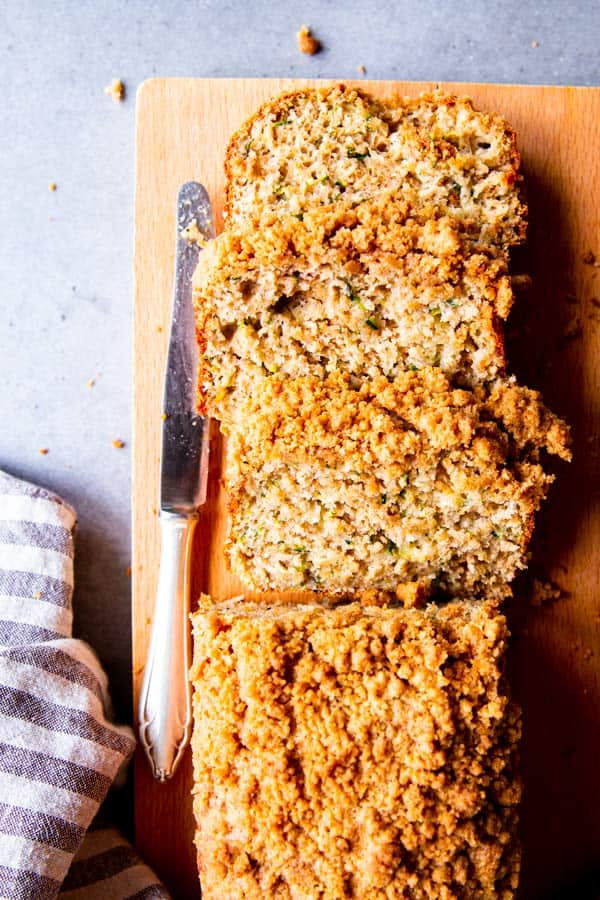 sliced cinnamon crunch zucchini bread on a wooden chopping board