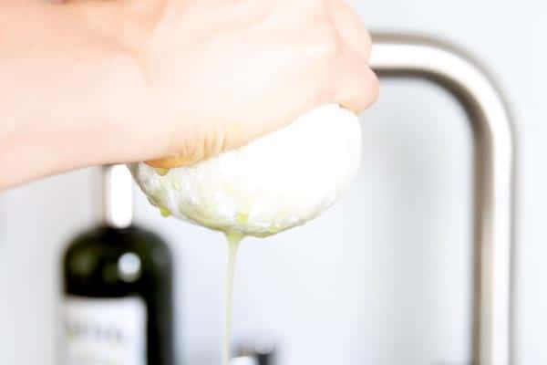 squeezing excess water out of shredded zucchini