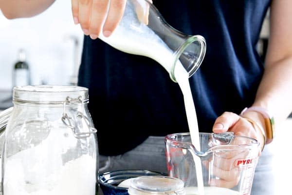 pouring buttermilk into a measuring jug