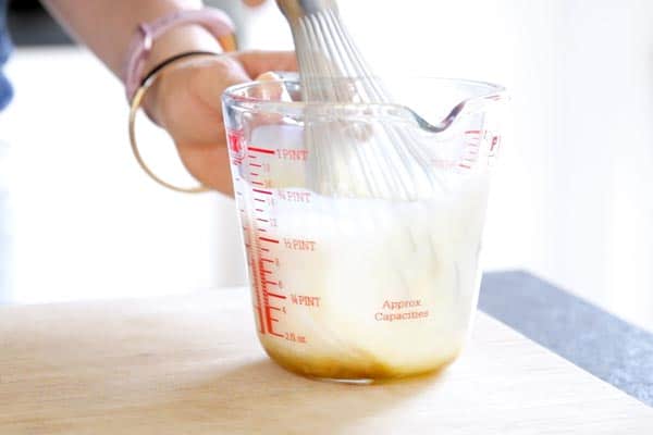 whisking wet ingredients for zucchini bread