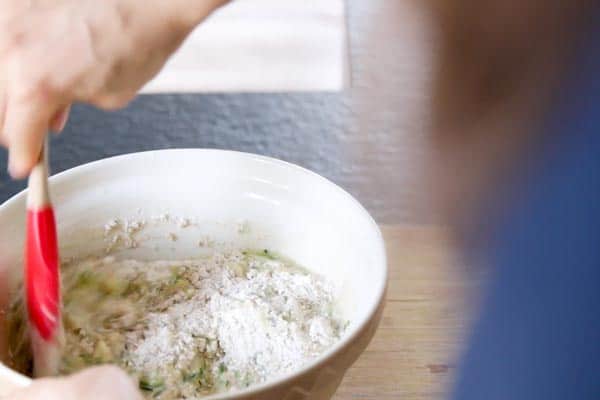 combining wet and dry ingredients for zucchini bread