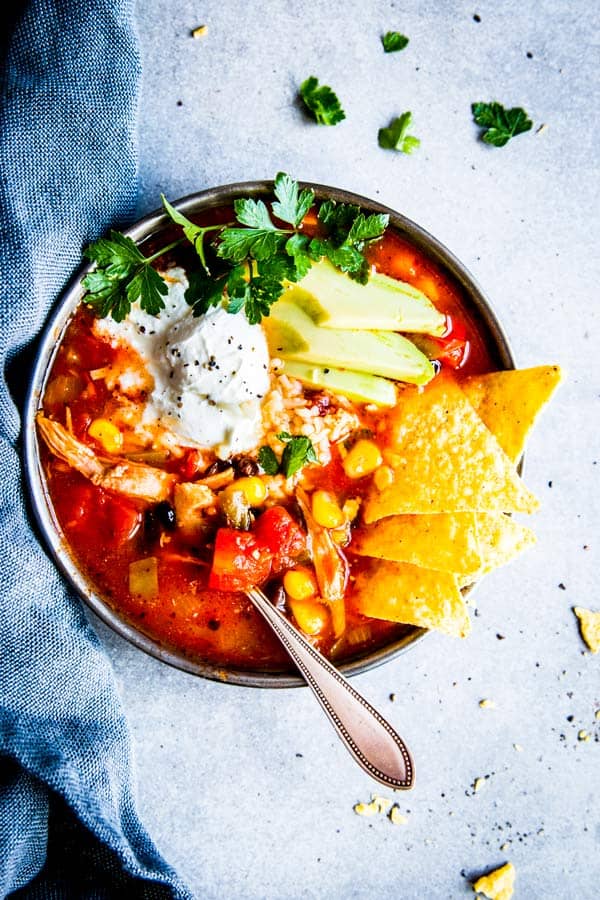 chicken tortilla soup in a black bowl