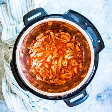 instant pot salsa chicken on the counter with a kitchen towel