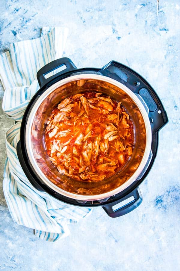 instant pot salsa chicken on the counter with a kitchen towel