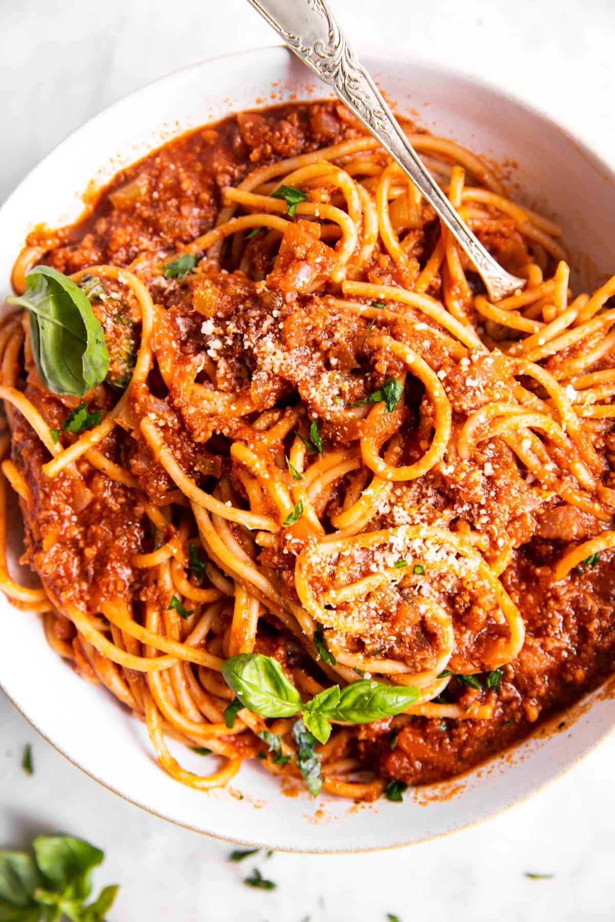 overhead view of one pot spaghetti with meat sauce in white bowl