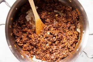 browned and seasoned ground beef with sofrito in skillet