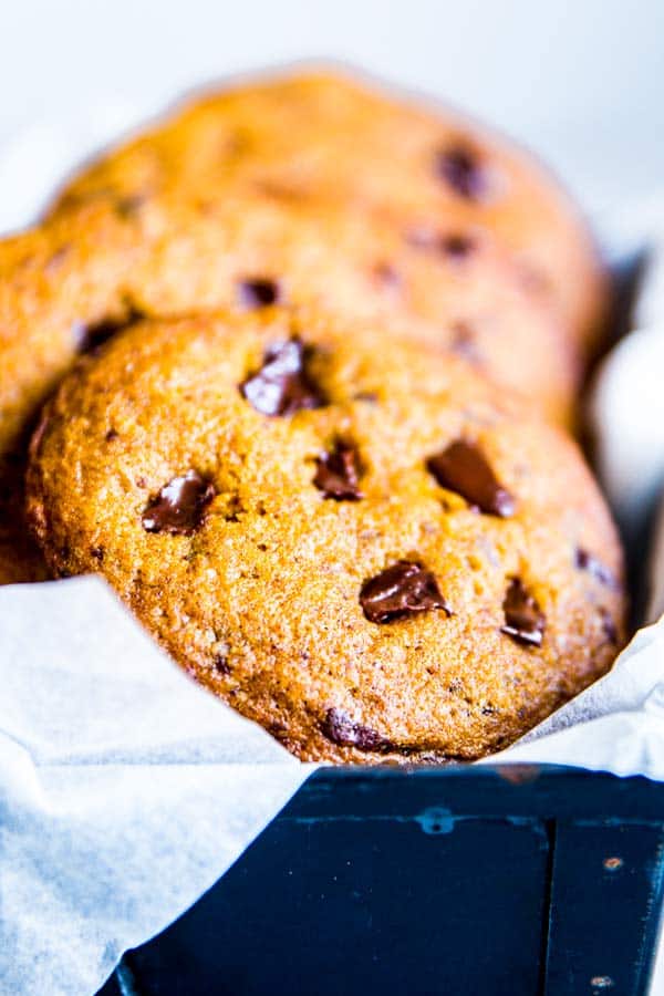 pumpkin chocolate chip cookies in a black tin