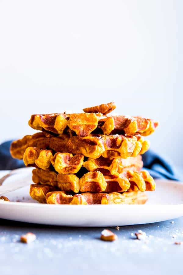 stack pf pumpkin pecan waffles on a white plate