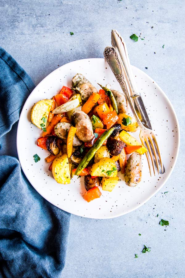 sausage potato and vegetables sheet pan dinner on a plate