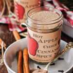 jar with apple cider spice mix on a Christmas decorated table