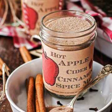 jar with apple cider spice mix on a Christmas decorated table
