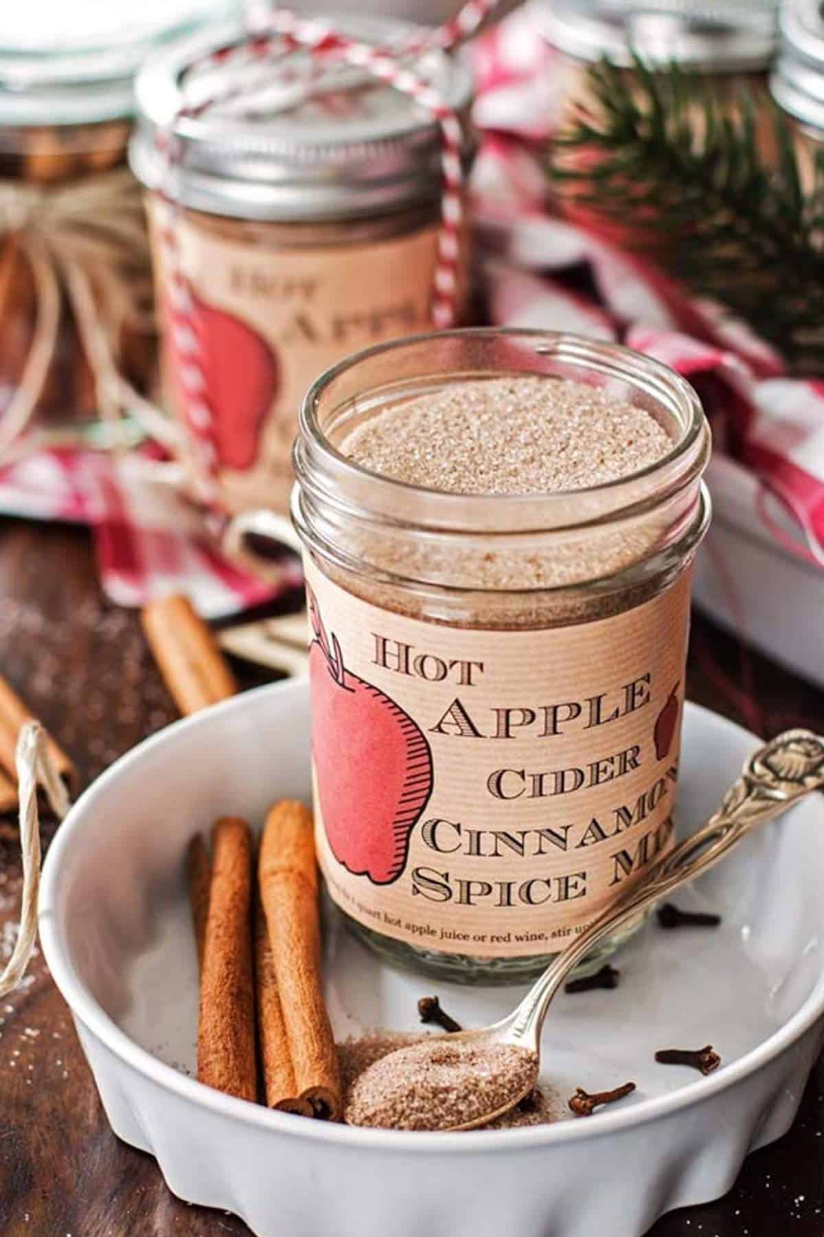 jar with apple cider spice mix on a Christmas decorated table