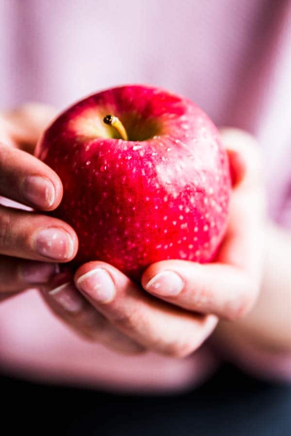 woman holding a red apple